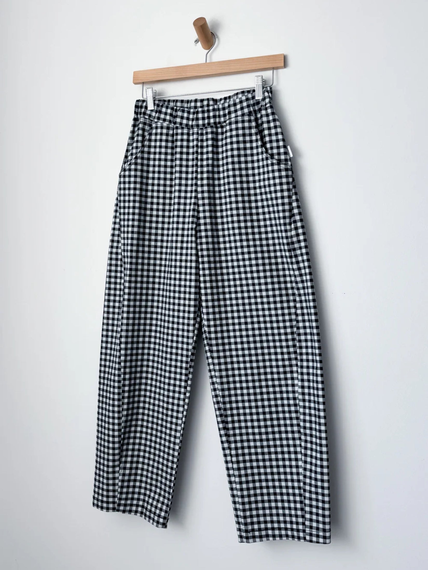 Navy gingham arc pants, showcasing their structured design.
