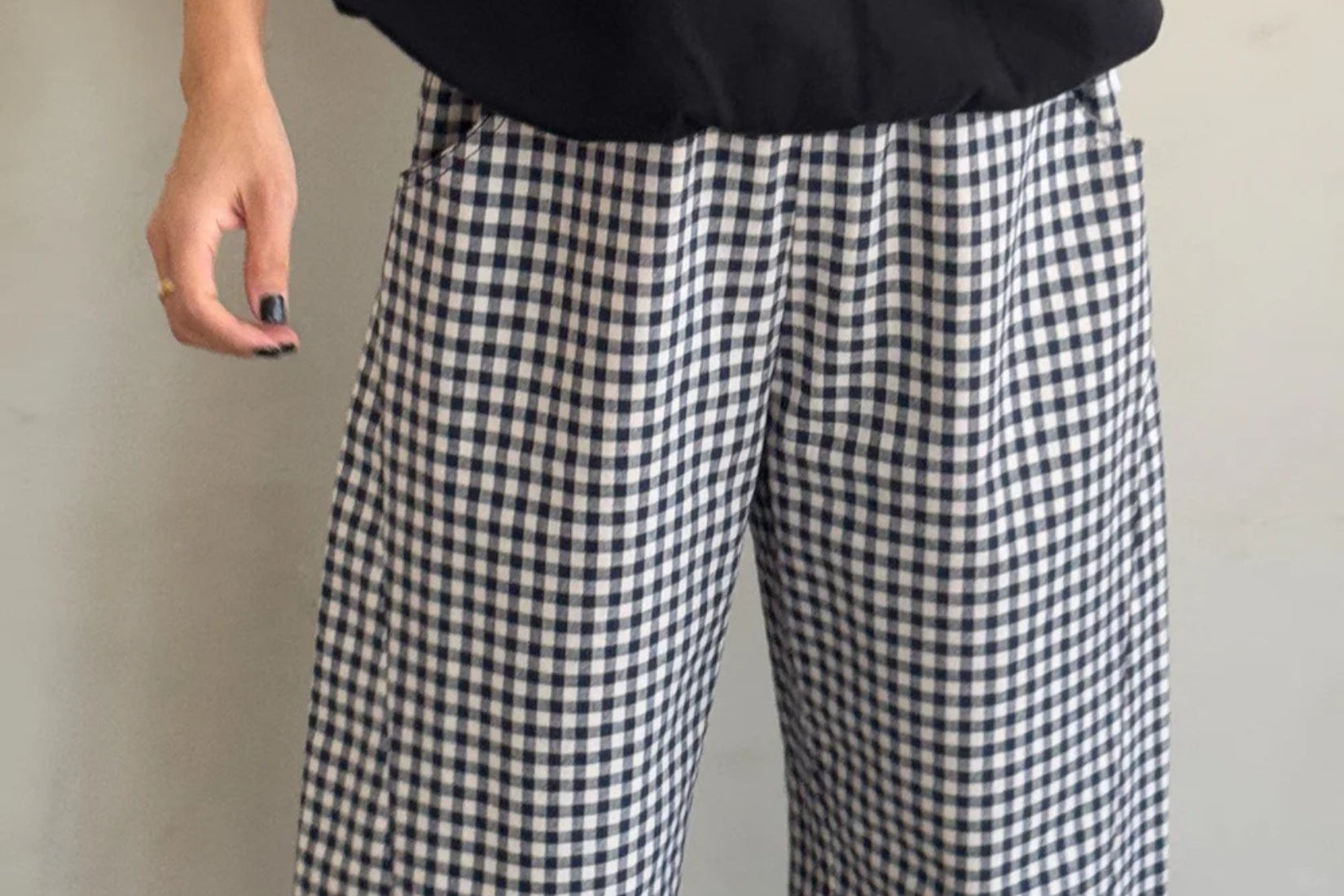 Model wearing navy gingham arc pants with a relaxed, contemporary fit.
