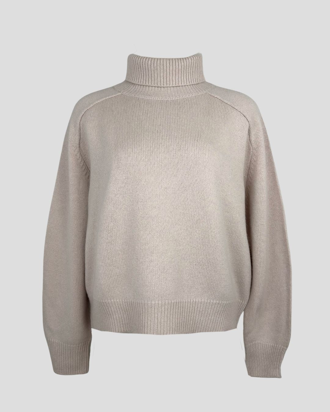 an elegant and simple styled cashmere turtleneck sweater in chalk pink.