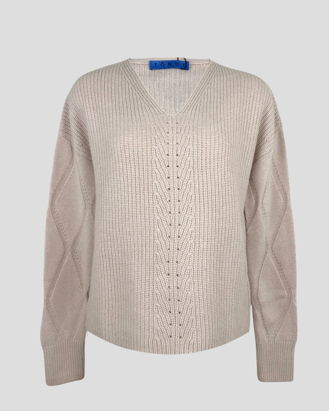 Chalk pink knit cashmere sweater  v-neckline, long sleeves photographed flat on a light background.
