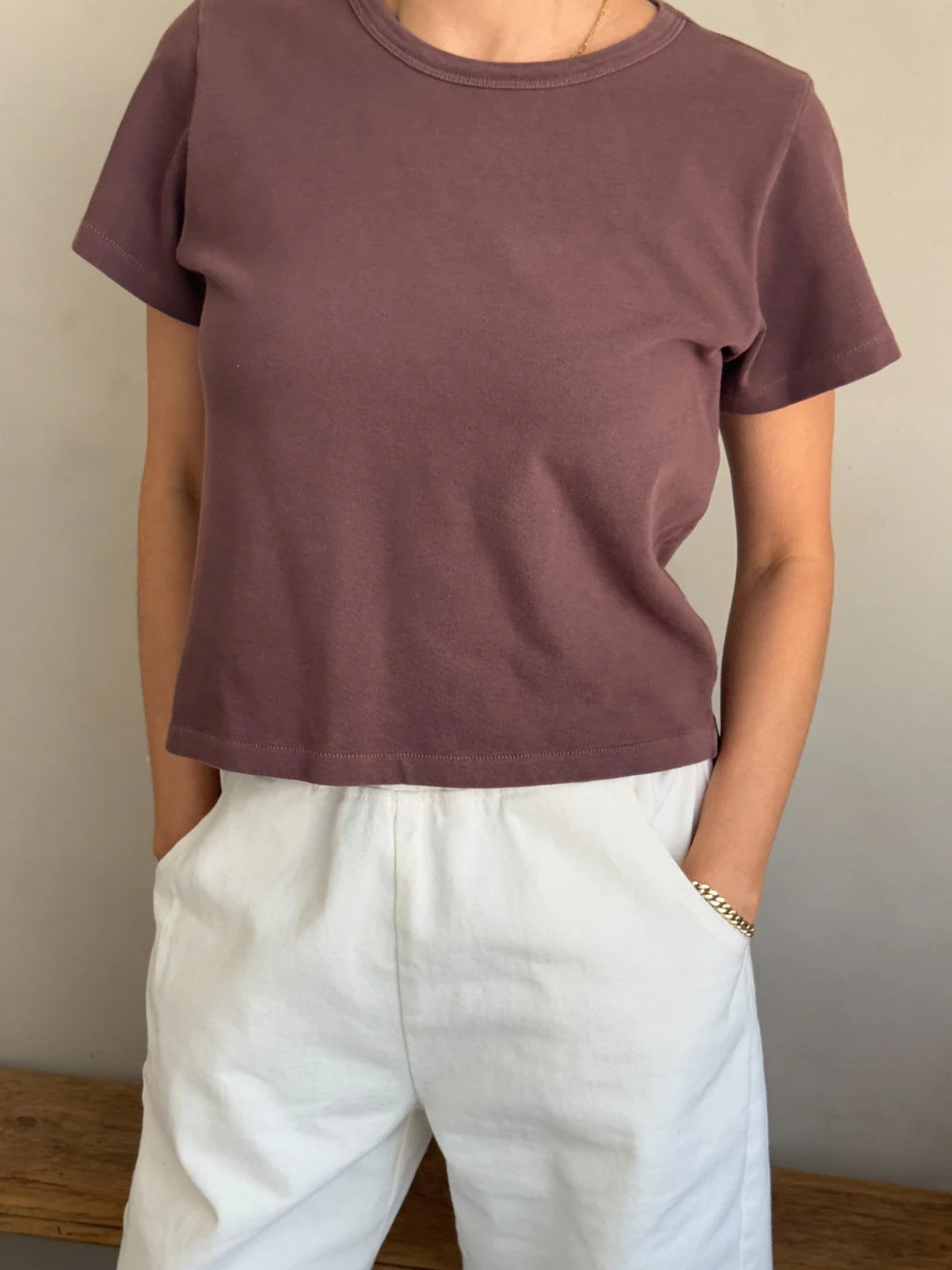 Model wearing a brown cotton t-shirt with a relaxed fit.